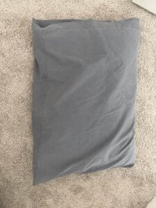 a pillow on a bedroom floor