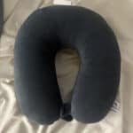 a travel pillow for neck pain on bed