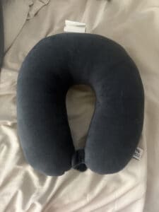 a travel pillow for neck pain on bed