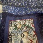 a quilt laid out on a bed