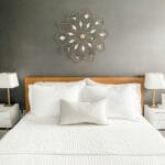 a bed made in a nice organized bedroom