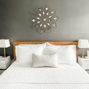a bed made in a nice organized bedroom