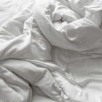 a heavy down comforter on a bed