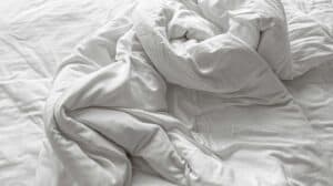a heavy down comforter on a bed