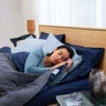 Woman sleeping peacefully in bed.