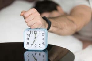 someone using their alarm while sleeping