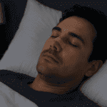 Man sleeping with nasal strip on