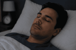 Man sleeping with nasal strip on