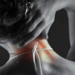 Person holding neck in discomfort