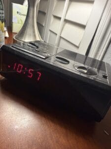 a standard digital alarm clock on nightstand