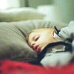 a toddler sleeping with a pillow