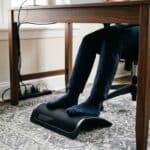 someone working remotely using under the desk footrest