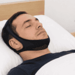 Man sleeping with chinstrap device