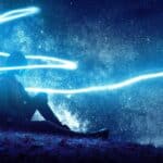 Person sitting under a starry sky.