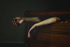 arms hanging off of bed during sleep