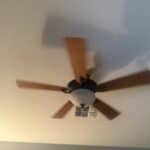 a ceiling fan in a bedroom