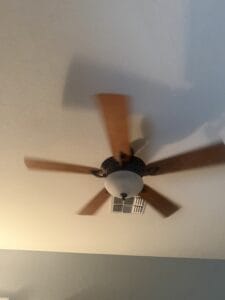 a ceiling fan in a bedroom