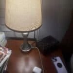 a charging nightstand with phone and airpods on nightstand