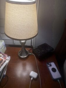 a charging nightstand with phone and airpods on nightstand