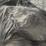 a cooling blanket laid out on bed