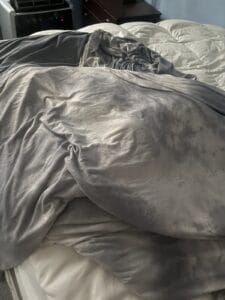 a cooling blanket laid out on bed
