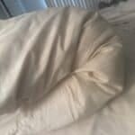 a cooling pillow bending on mattress