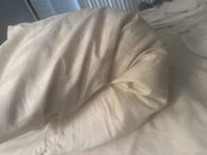 a cooling pillow bending on mattress