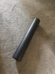 a diagonal foam roller on floor