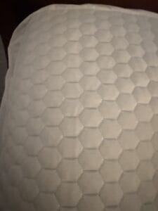 a laid out mattress topper for bed
