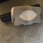cervical pillow and foam roller on floor