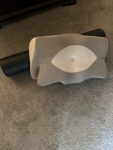 cervical pillow and foam roller on floor