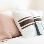 bunch of pillows laid out on bed
