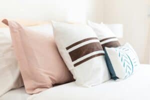 bunch of pillows laid out on bed