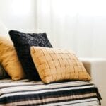 a lot of pillows on bed