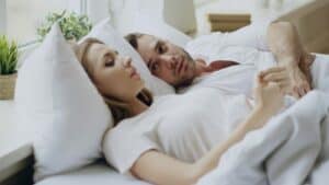 a couple sleeping in bed