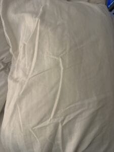 a satin pillowcase on a bed