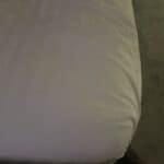 satin sheets on corner of a bed