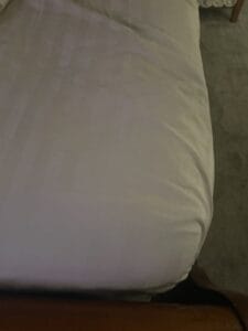satin sheets on corner of a bed
