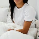 someone in bed mattress topper