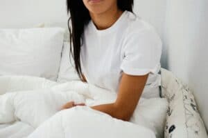 someone in bed mattress topper