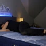 someone testing a mattress in store