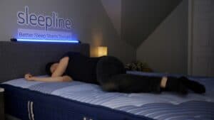 someone testing a mattress in store