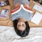 a teenager reading in bed