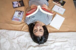 a teenager reading in bed