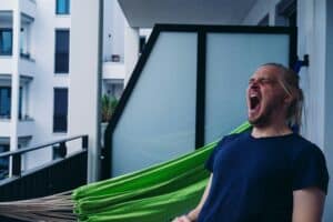 someone yawning mid day on patio
