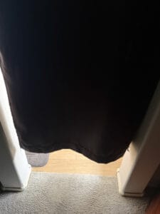 a blackout curtain in doorway cut off short