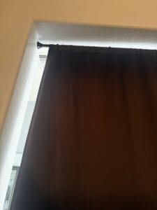a blackout curtain hanging from no drill rod