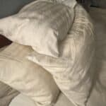 a bunch of pillows for winter on bed