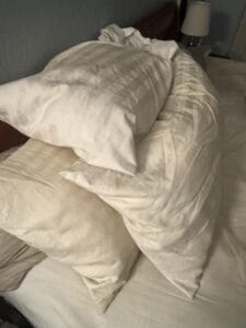 a bunch of pillows for winter on bed