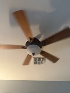 a ceiling fan spinning in bedroom